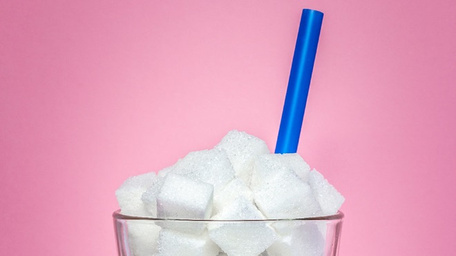 sugar cubes in a glass with straw